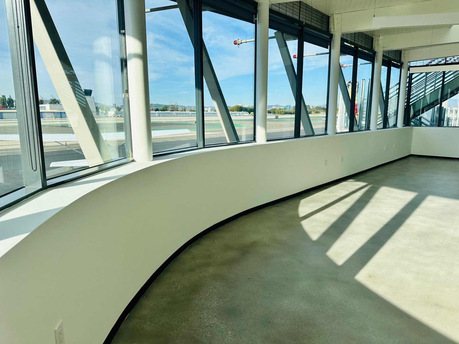 Curved window wall overlooking the airfield