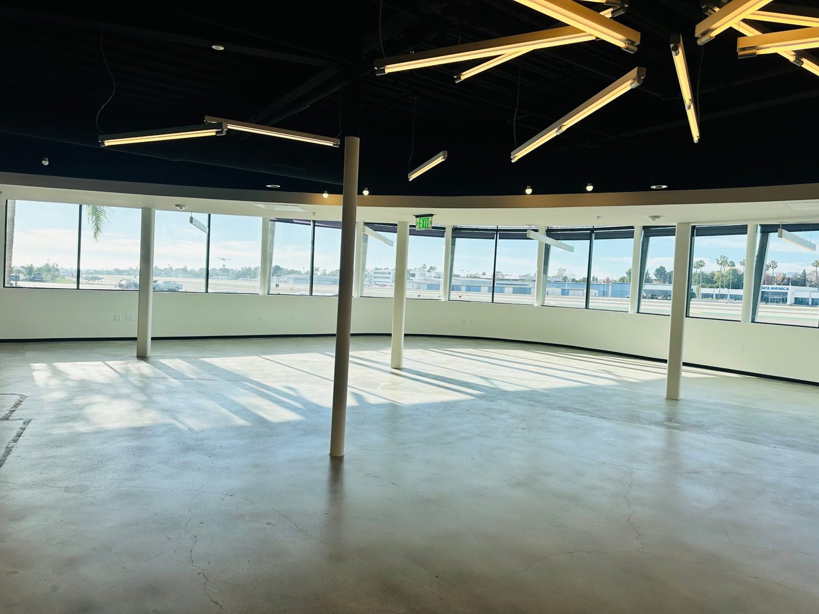 Open work area with feature lighting and airfield views